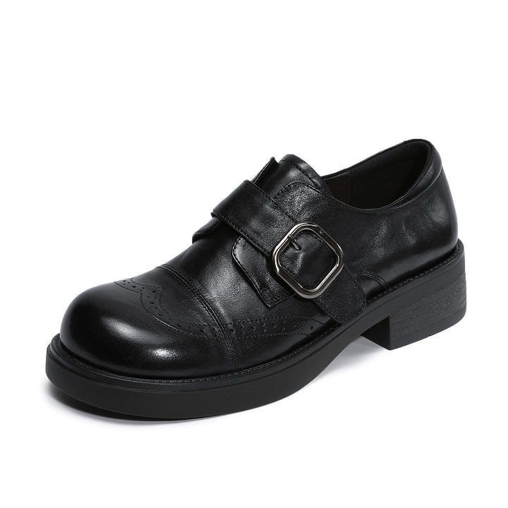 A single black leather platform shoe with a double strap closure and a silver-tone buckle, shown from a three-quarters angle on a white background.